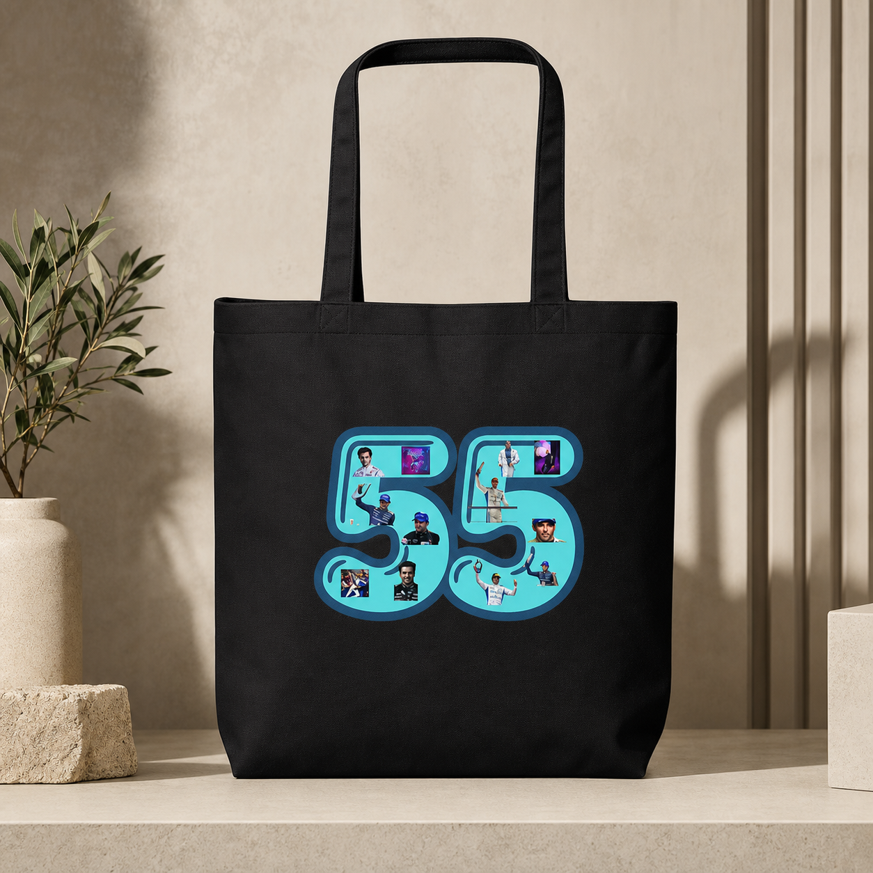 Black tote bag with a blue graphic design featuring the number 55 and various images on a neutral background.